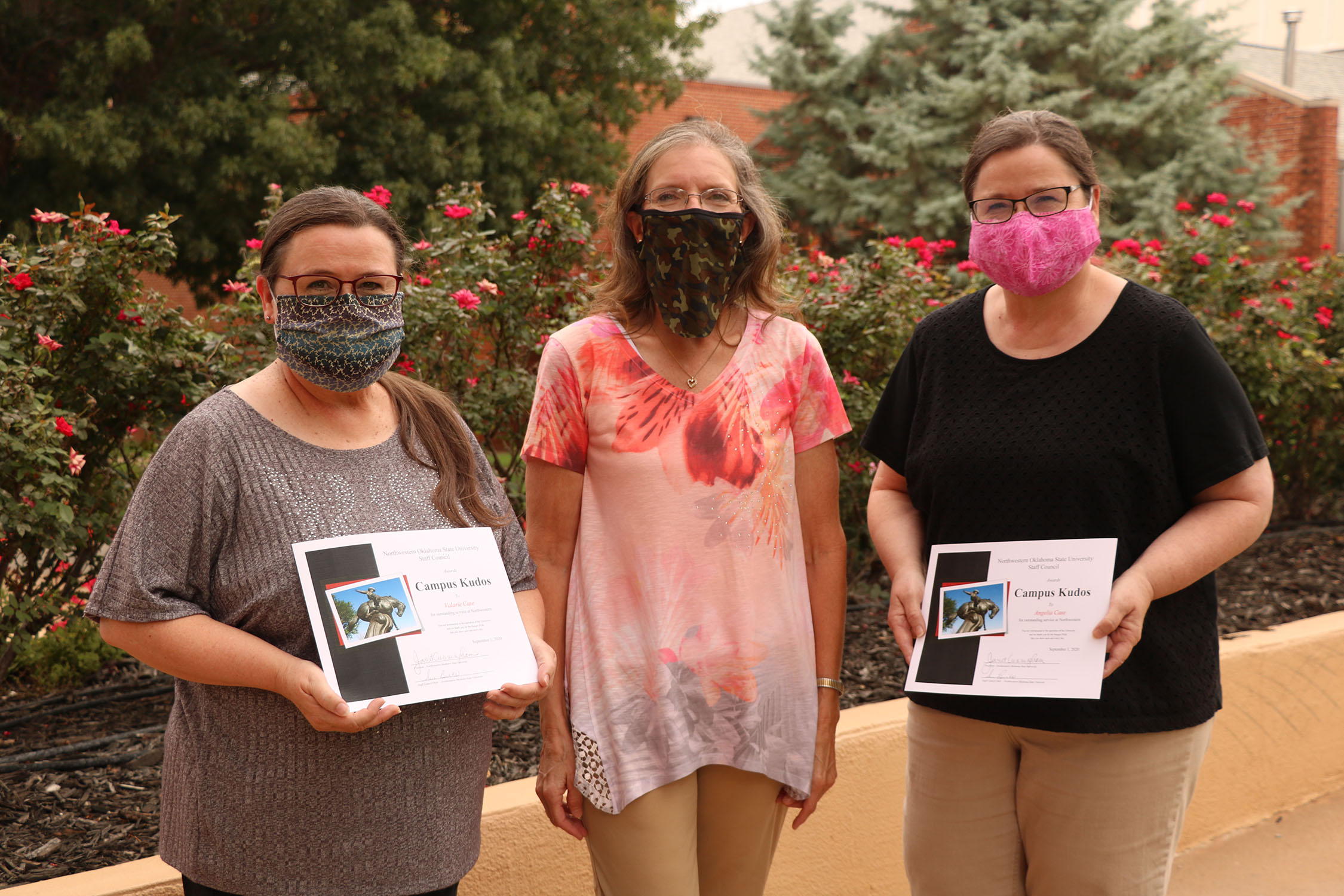 Sue Burks (middle) presents Angelia (right) and Valarie (left) Case with their summer Campus Kudos Awards.