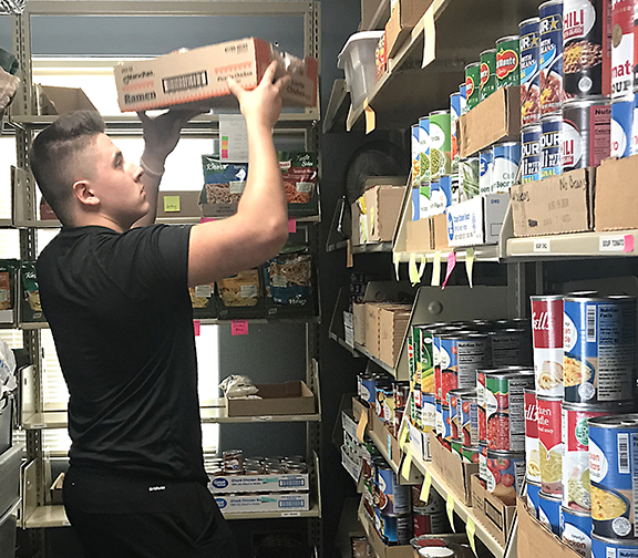 Dylan Collins working in the food pantry