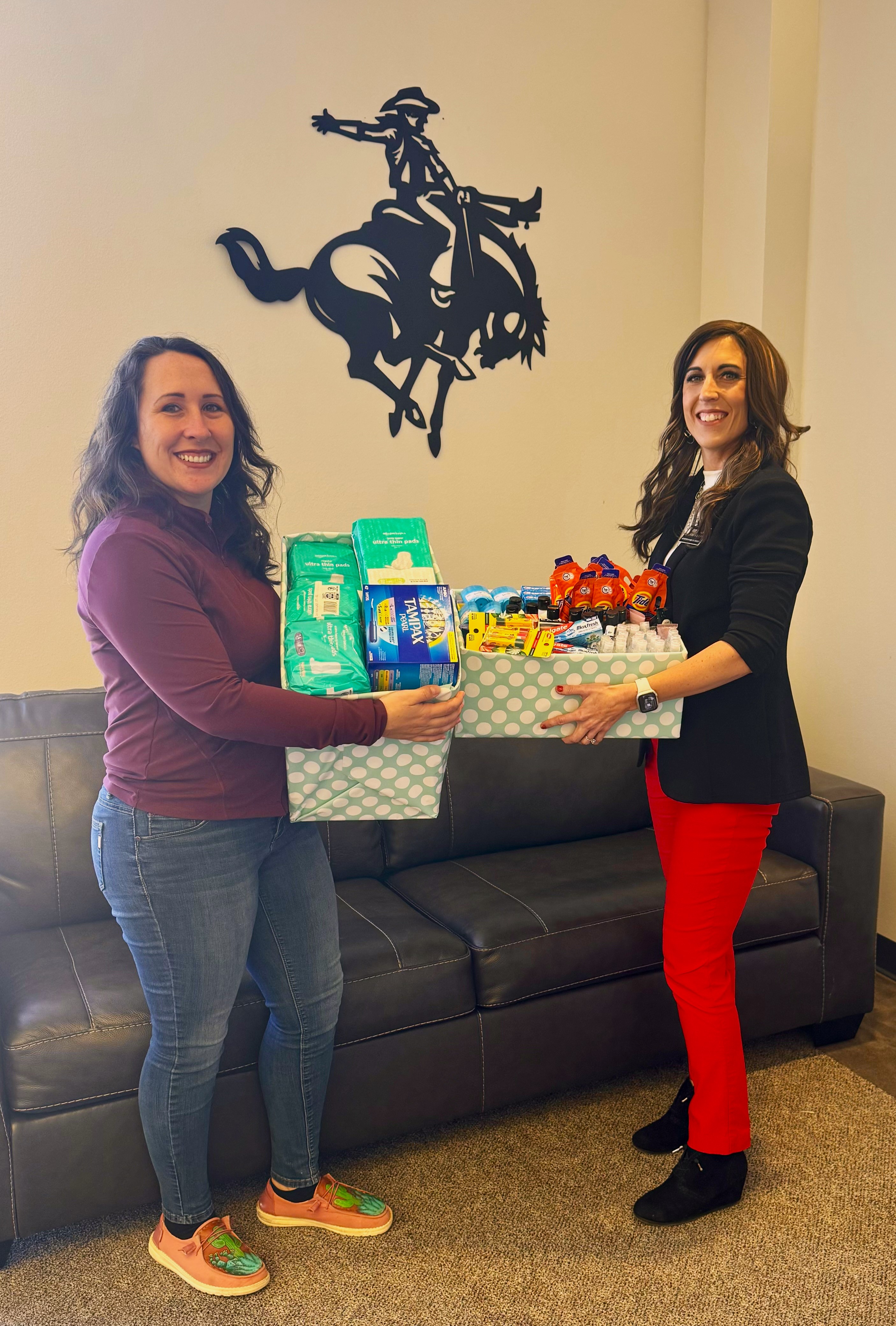 Melanie Yager (left) and Codi Harding (right) pose with the supplies donated to the 2023 ‘Compassion in Action’ Dignity Drive sponsored by the Northwestern Department of Social Work Social Workers Association of Tomorrow (SWAT) chapter. 