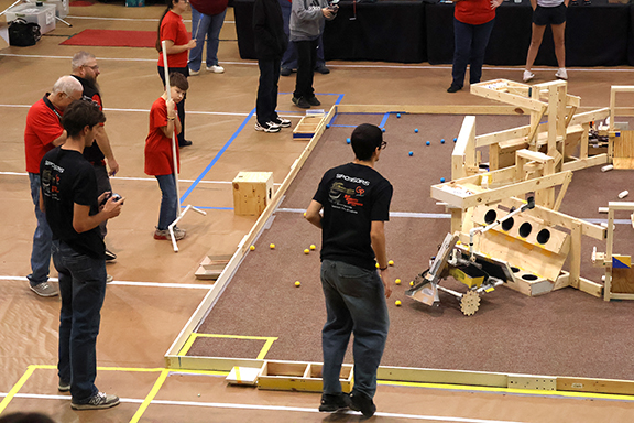 Arnett High School team members competing on the game floor during the Heartland BEST Robotics Contest at Northwestern-Alva.