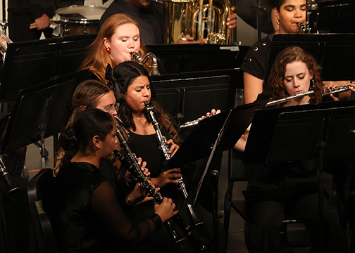 Northwestern symphonic band members playing instruments at last year’s Holiday Gala in Fellers Family Auditorium in Herod Hall.