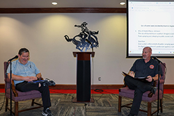 Dr. Eric Schmaltz (left) and Dr. Aaron Mason (right) have a discussion during the annual Constitution Day observance in 2024.