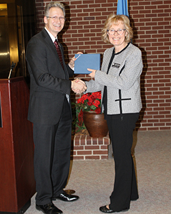 Dr. Steve Maier (left) presents Dr. Mariann Braten Hall (right) her 10-year service award.