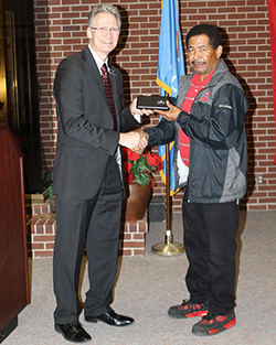 Dr. Steve Maier (left) presents A.J. Johnson. (right) his 20-year service award.