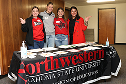 Northwestern Oklahoma State University Division of Education students (left to right) Janie Rempel, Teagen Wright, and Kate Mann pose with Northwestern instructor of education Yesenia Buckhaults (right) at the 2025 Future Educators Day.