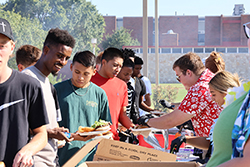 Members of the Northwestern Student Government Association serve meals to Northwestern students during the 2024 Aloha! Northwestern event.