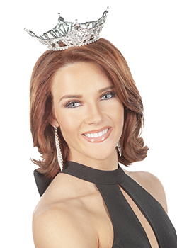 Abbey Elam, Miss Northwestern, poses for a headshot wearing a silver rhinestone crown, black halter-style gown and long crystal drop earrings against a white background.