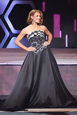 Abbey Elam, Miss Northwestern 2026, stands on the competition stage in a strapless black evening gown with lace bodice detail during the evening gown portion of the 2026 Miss Oklahoma Competition at Rose State College in Midwest City.