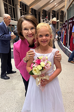 Jane Jayroe, Miss America 1967 and Laverne, Oklahoma native, stands with Hadleigh Dugger, Miss Northwestern's Star, at the 2026 Miss Oklahoma Competition at Rose State College in Midwest City. Dugger wears a white dress, tiara and sash and holds a bouquet of pink and yellow flowers.