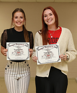 Reagan Hiner (left), a senior psychology major from Alva, and Paige Bailey (right), a senior psychology major from Enid, tied for Best Overall Project and first place in the Psychology category at the 20th annual Ranger Research Day at Northwestern Oklahoma State University on Nov. 21 in the J.W. Martin Library.