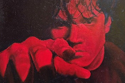 High contrast artwork in red and black tones depicting a person's face and raised hand in profile view.