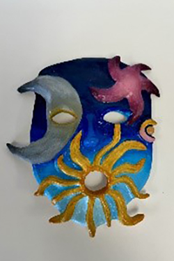 Ceramic wall hanging featuring a blue crescent moon, pink star, and yellow sun with radiating rays against a dark blue background.