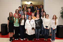Students who qualified for the Oklahoma State Science and Engineering Fair pose in four rows on a staircase at Northwestern Oklahoma State University. 