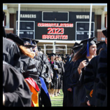 Northwestern Oklahoma State University graduates gather on Ranger Field during the 2023 commencement ceremony.