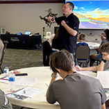 Casey Heiser with NextEra Energy visit with students at the camp.