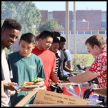 Members of the Northwestern Student Government Association serve meals to Northwestern students during the 2024 Aloha! Northwestern event.