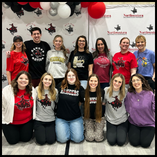 Primp for Prom volunteers pose in front of a Northwestern Oklahoma State University Social Work Department backdrop. 