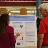 Dr. James Bell (right), vice president for academic affairs, listens to a DNP graduate’s presentation in the J.W. Martin Library during the 2024 DNP Residency Week.