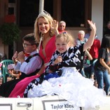 Homecoming parade float with people waving