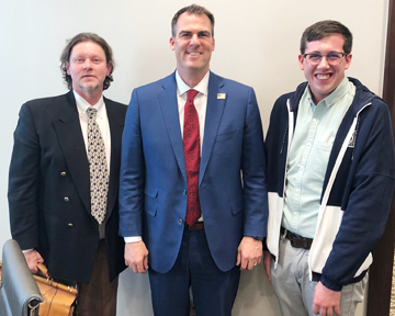 Northwestern senior social work major Jonathan Wales (right) is able to work alongside James Marks (left), executive director of the Oklahoma State Board of Licensed Social Workers, and on this particular day, Oklahoma’s Gov. Kevin Stitt during his field experience assignment in Oklahoma City this semester.