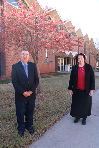 Dr. Pat Thompson (right) is presented the John Barton Distinguished Teaching and Service Award from its namesake.