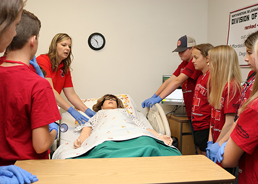 Dr. Leslie Collins (left) talks to the MASH Camp attendees about being a nurse and Northwestern’s nursing program.