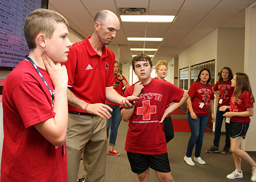Shane Hansen helps the MASH Campers learn how to determine their heart rate before and after exercising.