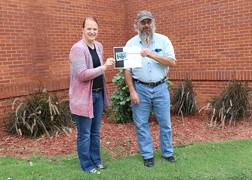Lisa Vermillion (right) presents Shawn Smith with a summer Campus Kudos Awards.