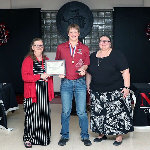 Sattler and Riegel present the Division I Reserve Champion award to Eli Harrel from Vici Public Schools.
