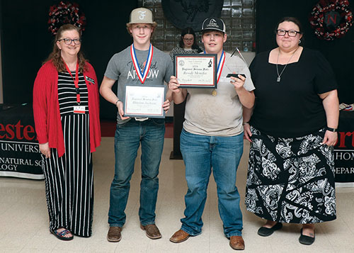 Sattler and Riegel present the Division II Grand Champion award to Rowdy Menefee and Rhielan Jackson from Vici Public Schools.