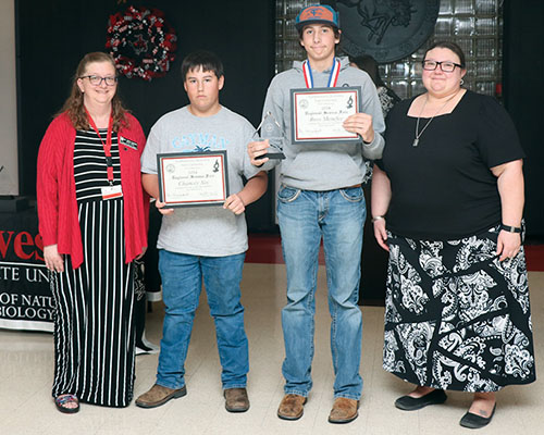Sattler and Riegel present the Division II Reserve Champion award to Ross Menefee and Chancey Nix from Vici Public Schools.