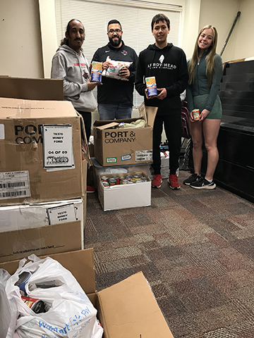 Northwestern athletics personnel volunteered to move more than 10 boxes of food donations weighing 861 pounds from a recent food drive at a Ranger basketball game to the Northwestern Campus Cabinet food pantry in Shockley Hall. Helping are Sterlin Broomfield, head men’s/women’s cross-country coach; Tim Lauderdale, associate director of athletics for internal operations; Edward Robledo; El Paso, Texas, freshman majoring in political science; and Seriah Vess, Tulsa freshman undecided. Not pictured but helping are Aaron Medrano, Laredo, Texas, junior majoring in mass communication; and Harley Woody, Oklahoma City freshman majoring in psychology.
