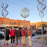 Helping to install a new public art piece on Alva’s downtown square are Northwestern student-athletes Blake Hoffman, Koby Spicer and Harry Park, along with Alva Public Art Committee members Jim Richey and Warren Little.