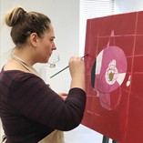 Northwestern’s latest artist-in-residence Yelena Martynovskaya works on a painting that will be on display in downtown Alva during the First Friday Art Walk Feb. 7. On Feb. 12, she is leading a free abstract art workshop open to the public.