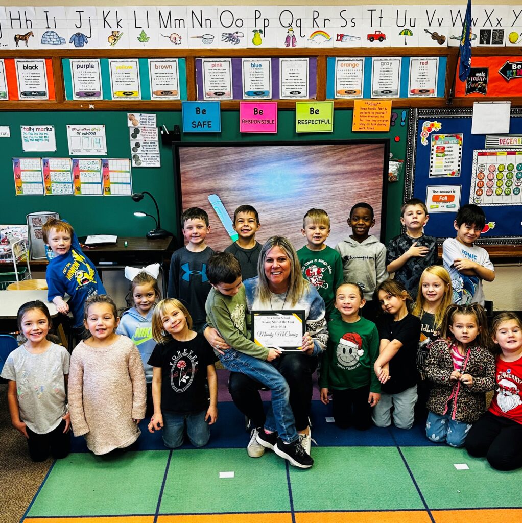 Amanda McCamey poses with her kindergarten class and Alva Public Schools Rising Star Award in her classroom at Washington Early Childhood Center.