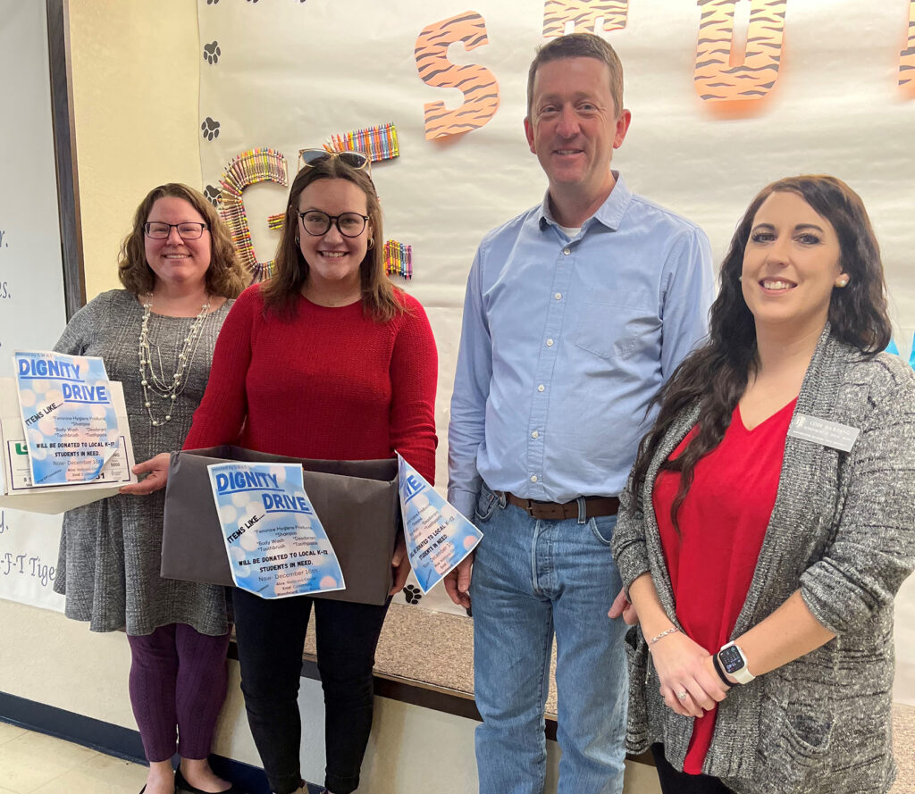 Taft Elementary School in Enid receives donations from the Northwestern Oklahoma State University SWAT Compassion in Action Dignity Drive. (Left to right) Ashley Garner, SWAT president, Bishop Buck, SWAT vice president, Robert Kappus, Taft Elementary School principal, with Codi Harding, SWAT sponsor and assistant professor of social work.