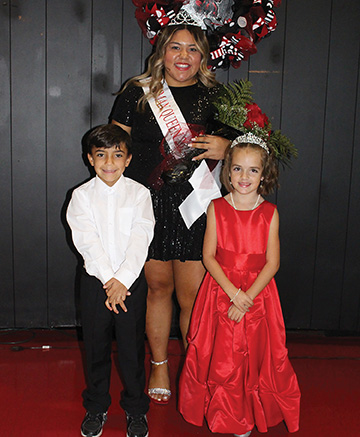 Freshman Queen Brenda Lesama with Braxton Lauderdale, crown bearer, and Justice Jones, flower girl.
