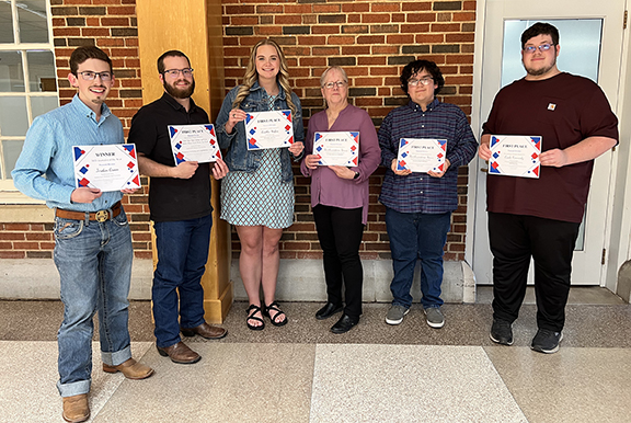 Northwestern News staff members pose with award certificates during the Oklahoma Collegiate Media Association Conference in Stillwater on April 13. Attending the event are (left to right) Editor-in-Chief Jordan Green, Senior Reporter Benjamin Kliewer, Features Editor Caitlin Hofen, Adviser Dr. Kaylene Armstrong, Advertising Manager Derrick Galindo and Sports Editor Cade Kennedy.
