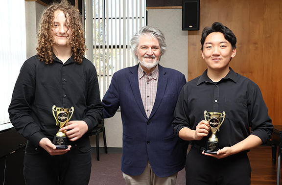 Placing top two at the Northwestern Oklahoma State University Guitar Festival March 31 in Alva are Enid High School’s Jacob Hassler (right, first place) and Enid’s Waller Middle School student Noah Webb (left, second place). Max Ridgway (center) is the coordinator of the Guitar Festival.