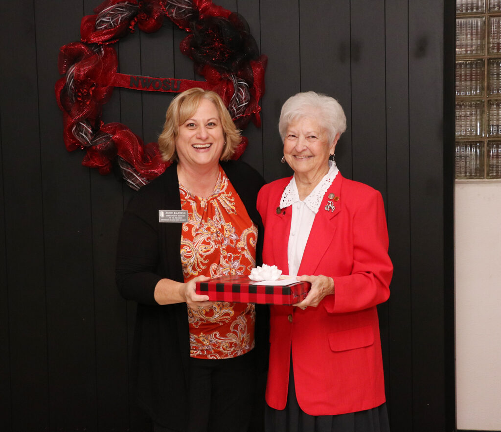 (Left) Jodie Randels, administrative assistant to the president, is presented with the Thelma Crouch Staff Employee of the Year award from its namesake.