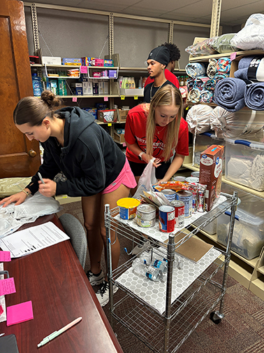 The Northwestern Campus Cabinet Food Pantry in Alva has numerous student volunteers who help each semester with various tasks. Here, students Ella Porter, Elk City sophomore majoring in Health and Sports Science Education (HSSE); Carson Schanbacher, Cherokee sophomore majoring in HSSE; Clarence Miller, Edmond junior majoring in HSSE; and Damonta Jones, Midwest City freshman majoring in sociology, are earning hours for a Habitudes class by filling a food order for a pantry client.