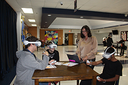 Morgan Dutton works with students using virtual reality technology as part of a hands-on learning activity at Kingfisher High School.
