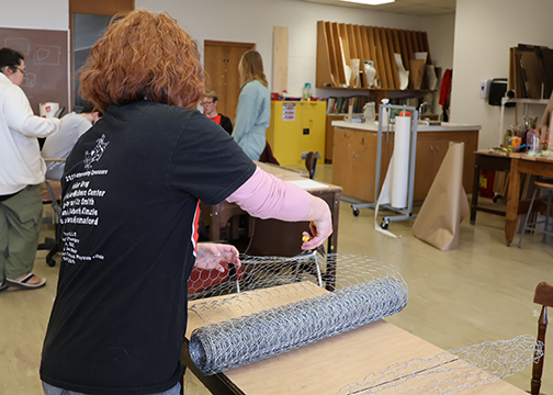 Katelyn Findley prepares for her senior art exhibition starting April 20 in the Gallery Sophia in Jesse Dunn 218 by cutting some wire.