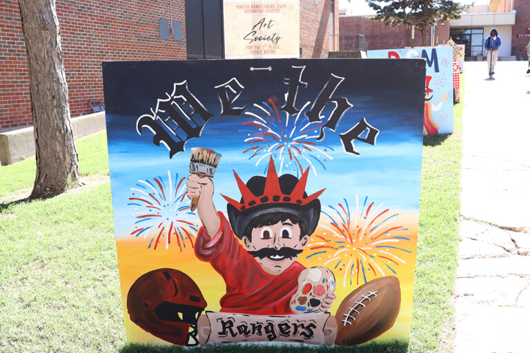 The Northwestern Art Society’s first-place spirit board shows Rowdy with a paintbrush and crown in front of fireworks, with the words “We the” and “Rangers,” displayed on the Northwestern Oklahoma State University campus in Alva, Oklahoma.