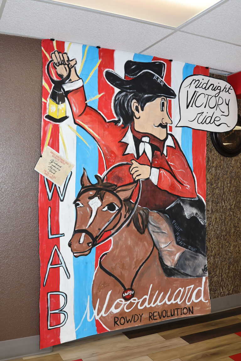 The Woodward Leadership Advisory Board’s first-place spirit sheet shows a cowboy on horseback holding up a lantern, with the words “Midnight Victory Ride,” “WLAB” and “Woodward Rowdy Revolution.”