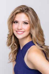 Nelley Burnett, Miss Northwestern’s Teen contestant, in a navy sleeveless top, against a gray background.