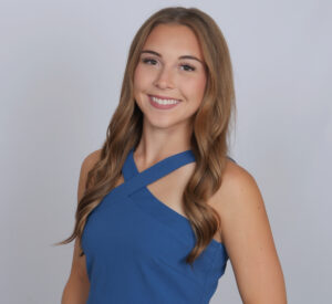 Loralei Welch, Miss Northwestern’s Teen contestant, in a blue crisscross halter top, against a gray background.