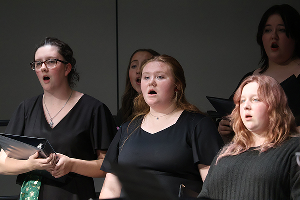 NWOSU Choir members singing at a concert.