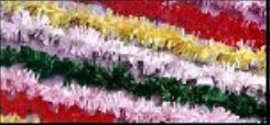 Twisted garland strips of red, white, green and yellow festooning laid side by side.