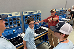 STEM camp students (left to right) Wyatt Bell, Alexander Burch, Kevin Dixon (HPTC instructor), and Julian Close learn about electrical systems at High Plains Technology Center in Woodward.